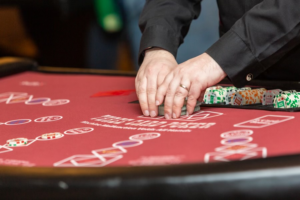 A dealer shuffles cards for a poker game.